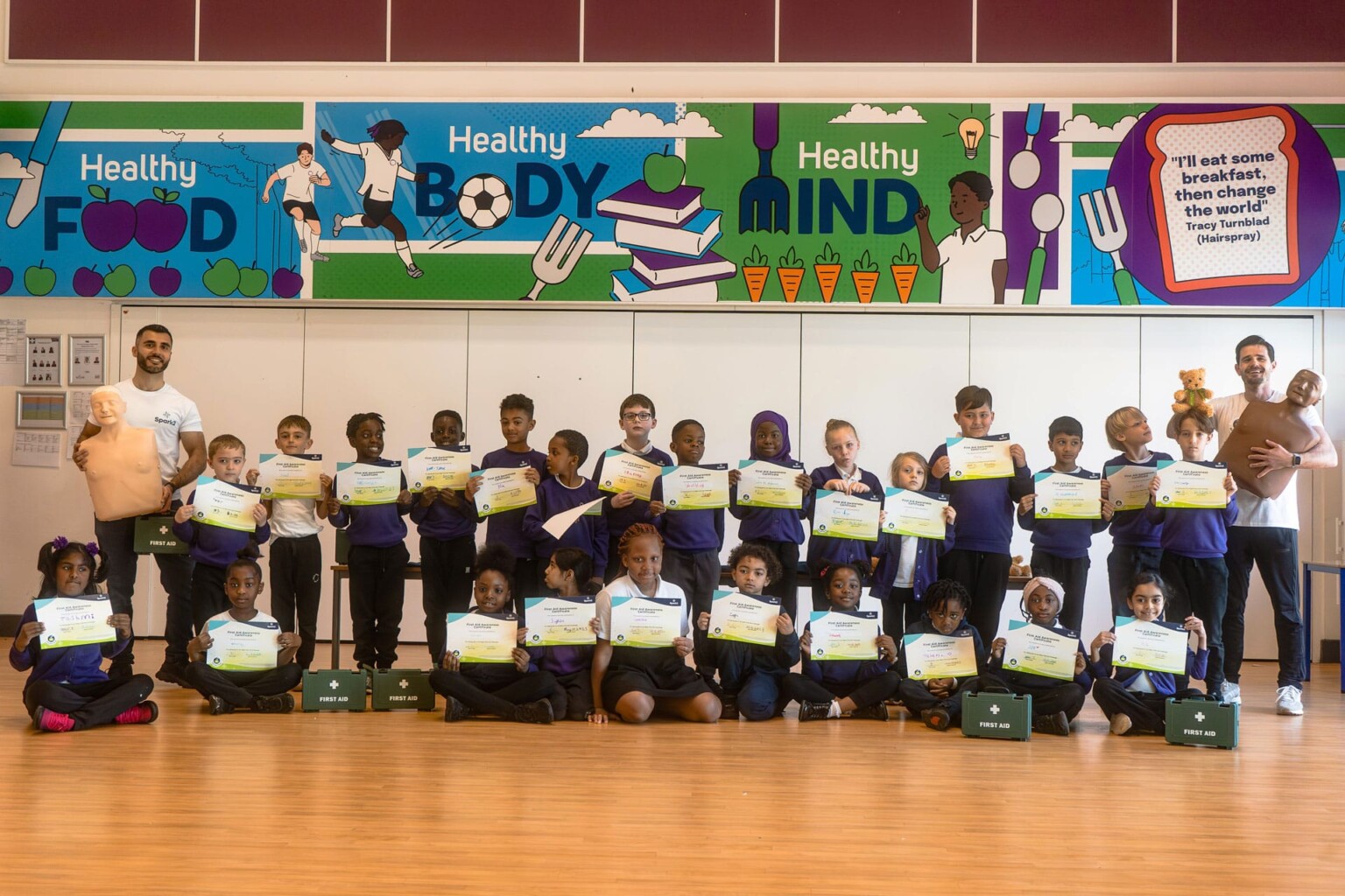 Primary school children holding up their certificates